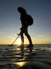 woman metal detecting